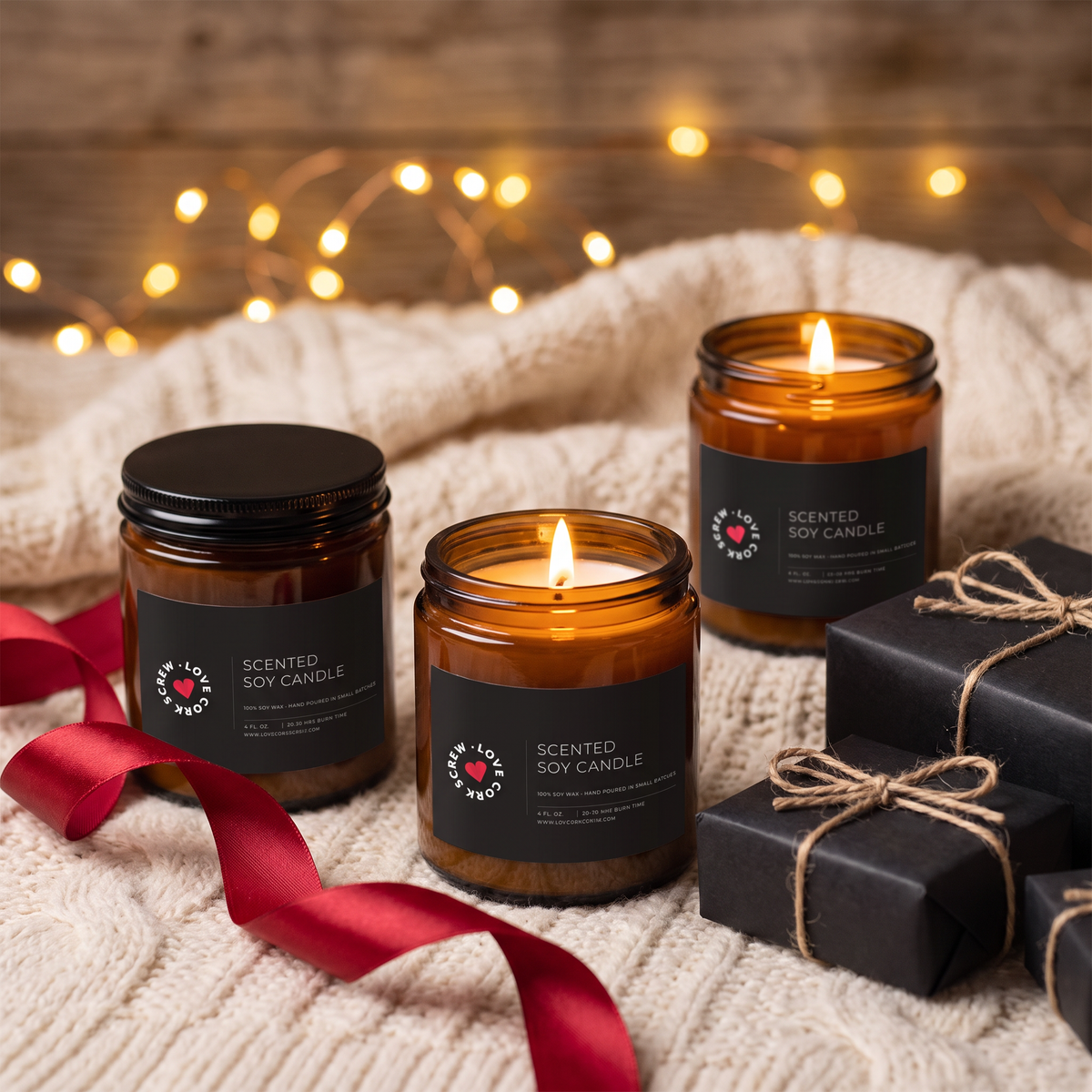 Three Love Cork Screw 4oz soy candles on a knit blanket with red ribbon and wrapped gifts